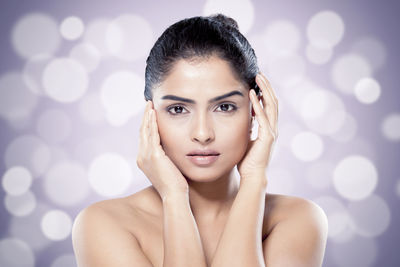 Portrait of beautiful woman against colored background