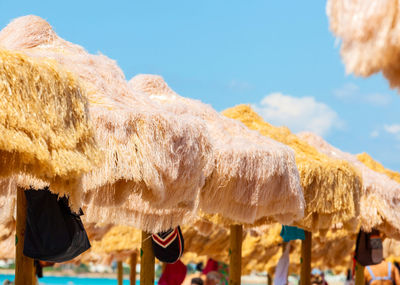 Beach beautiful thatched umbrellas and turquoise sea.