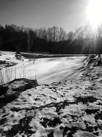 Scenic view of frozen lake against sky during winter