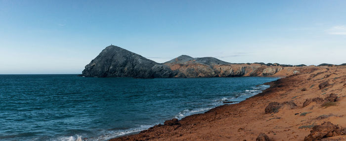 Scenic view of sea and mountains against sky