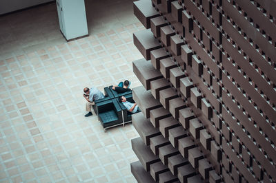 High angle view of people sitting on chair