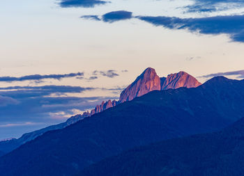 Scenic view of mountain range against sky during sunset