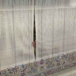 Person holding umbrella against wall