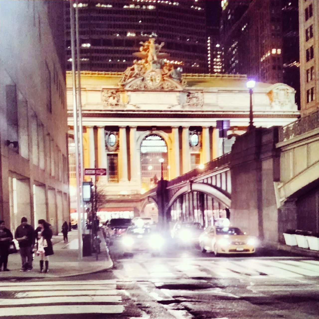 architecture, built structure, building exterior, illuminated, night, city, motion, city life, men, blurred motion, fountain, long exposure, large group of people, street, person, city street, travel destinations, incidental people, lifestyles