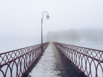 Footbridge over street during winter