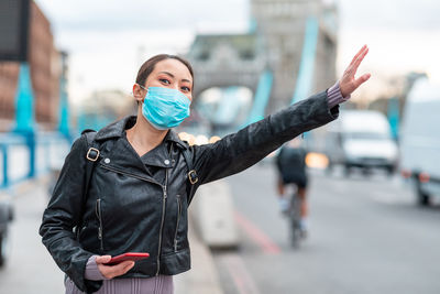 Woman wearing mask standing on street