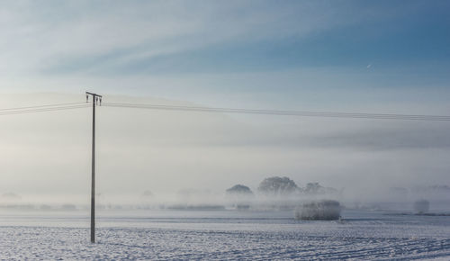 Scenic view of landscape against sky during winter