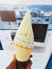 Close-up of hand holding ice cream cone