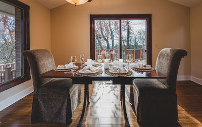 Dinner table with two chairs is set for two dinner guests