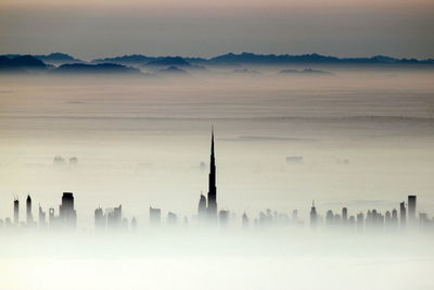 High section burj khalifa and skyscrapers during foggy weather