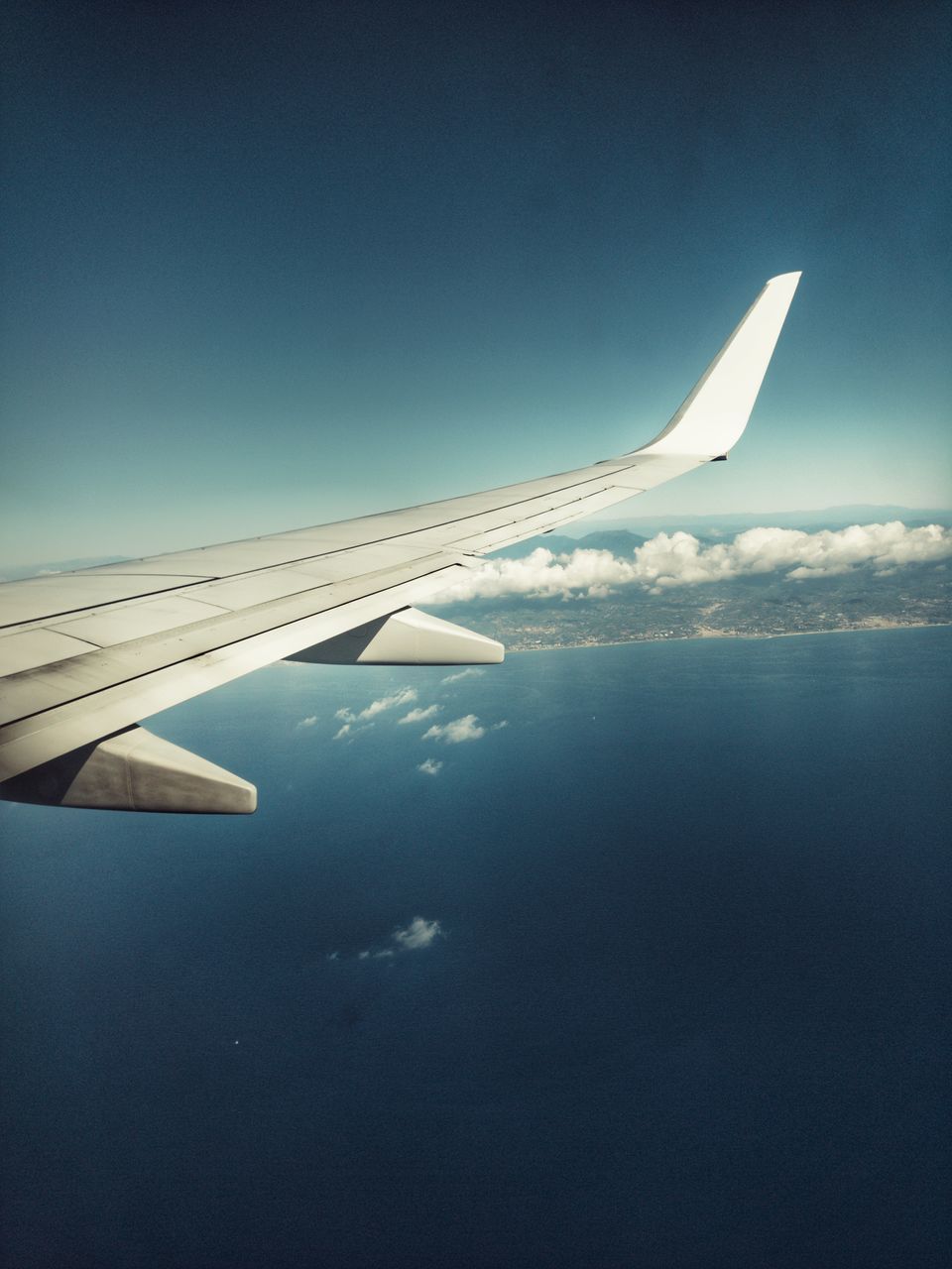 AERIAL VIEW OF AIRPLANE WING OVER THE SKY