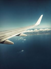 Aerial view of airplane wing flying in sky