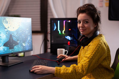 Side view of young woman working at table