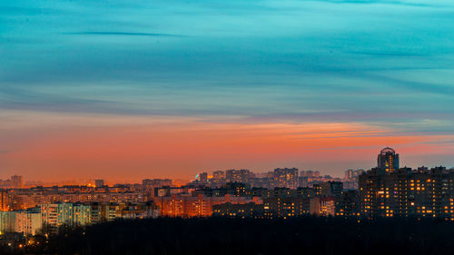 High angle view of illuminated buildings against sky during sunset