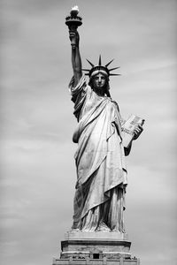 Low angle view of statue of liberty against sky