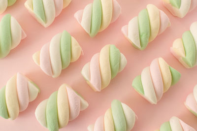 Colorful marshmallows composition on a pink background - copy space - children candies concept