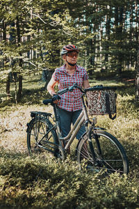 Full length portrait of smiling boy on bicycle