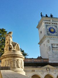 Low angle view of statue against clear blue sky