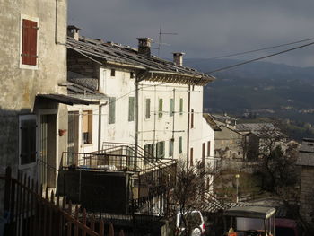 Low angle view of buildings in town against sky