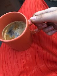 Midsection of person holding coffee cup