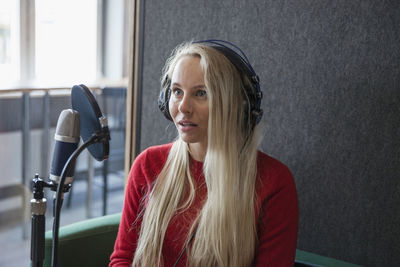 Smiling woman talking to microphone