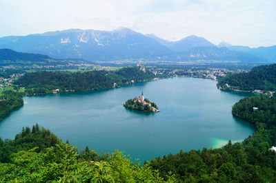 High angle view of lake and mountains against sky