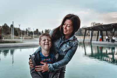 Portrait of mother and son on water