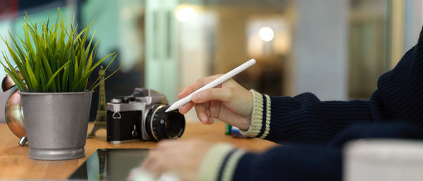 Cropped hands using graphics tablet at desk