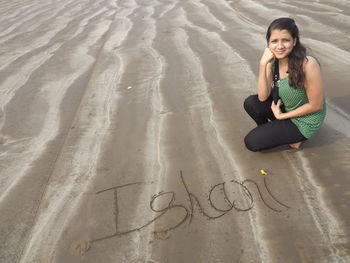 High angle view of woman standing on beach