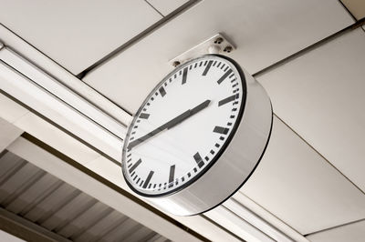 Low angle view of clock on ceiling