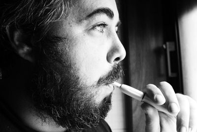 Close-up of man holding cigarette