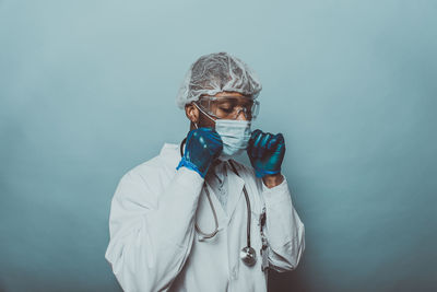 Portrait of woman standing against blue sky
