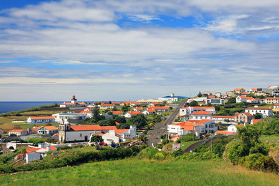 Town by sea against sky