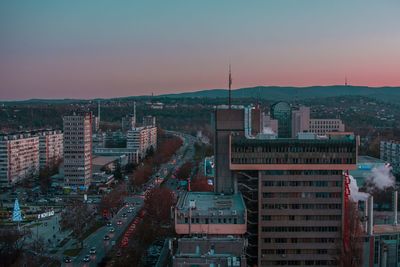 High angle view of buildings in city at sunset