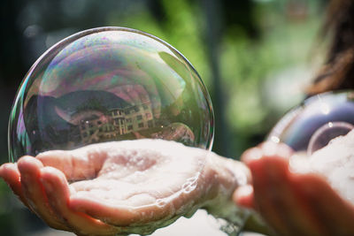 Close-up of hand holding bubbles