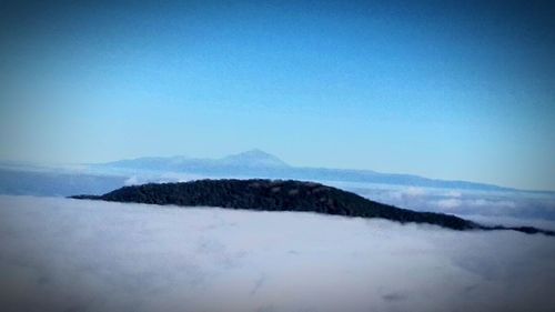 Scenic view of mountains against clear blue sky