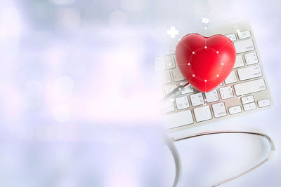 Digital composite image of heart shape model and computer keyboard