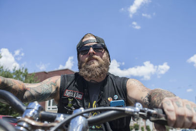 A young man riding a motorcycle.