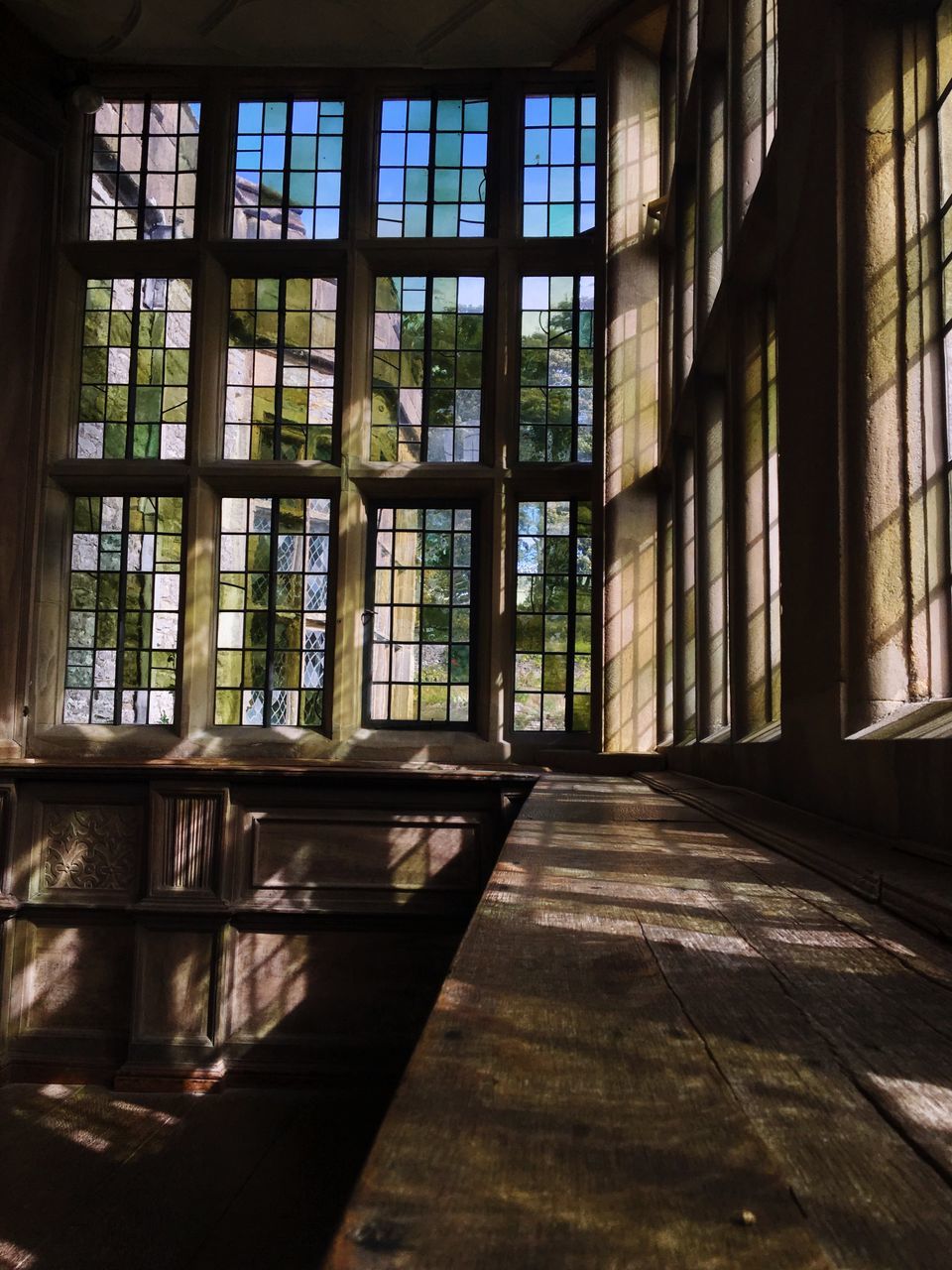 window, architecture, built structure, indoors, day, building, sunlight, no people, glass - material, shadow, flooring, absence, nature, wood - material, transparent, empty, pattern, glass