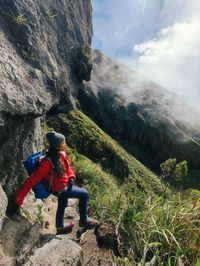 Rear view of man standing on mountain