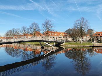 Arch bridge over river against sky