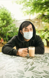 Portrait of man drinking coffee