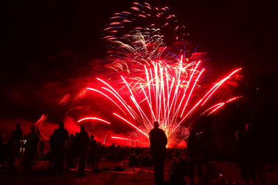 Low angle view of firework display at night