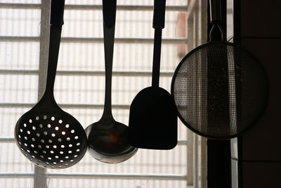 Close-up of clothes hanging on window at home