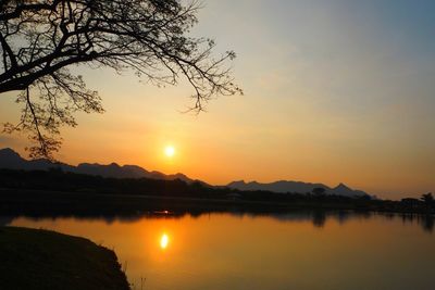 Scenic view of lake against romantic sky at sunset