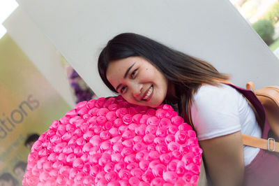 Portrait of smiling woman holding rose bouquet 