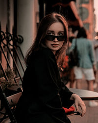 Portrait of young woman wearing sunglasses