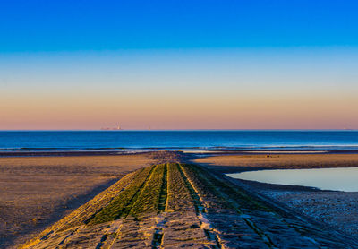 Scenic view of sea against clear blue sky