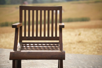 Close-up of empty bench on field