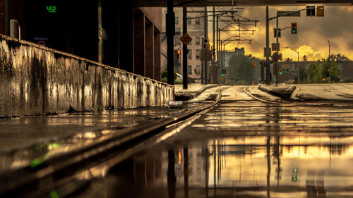 Reflection of building in puddle on street